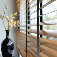 Faux wood blind, next to vase